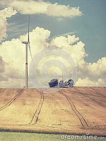 Cheap energy. Wind energy turbines in field with blue sky Stock Photo