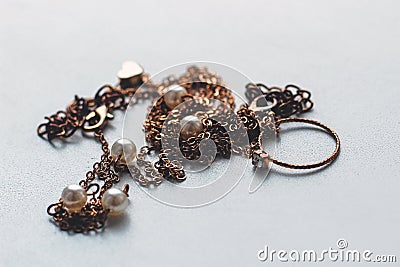 cheap jewelry chain bracelet and ring blackened from water on white background. Stock Photo