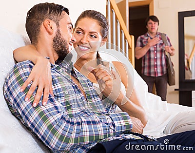 Cheating partner coming home Stock Photo