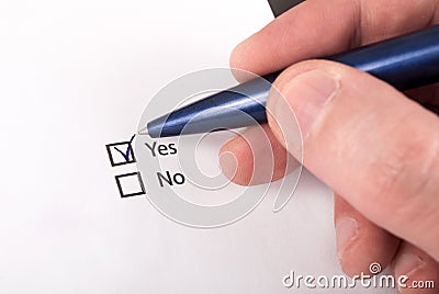 Decision-Making: Close-Up of Hand Checking Yes on Checkboxes Stock Photo