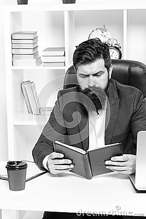 Check if i have time today. Man bearded hipster boss sit in leather armchair office interior. Boss at workplace. Manager Stock Photo