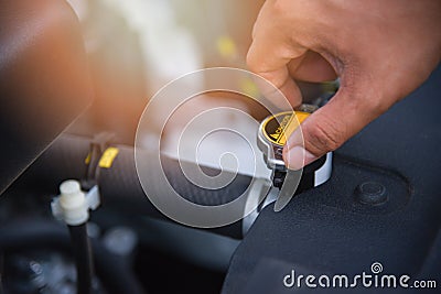 Check radiator car with hand on engine in the car service center Stock Photo