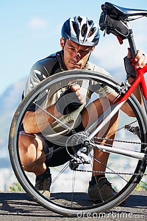 Check, wheel and man with bicycle on road, street and outdoor exercise with flat tire. Cycling, athlete and closeup on Stock Photo