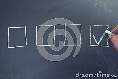 Checked the box by symbol of tick on chalkboard Stock Photo