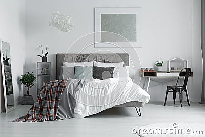 Checkered blanket on the bed Stock Photo