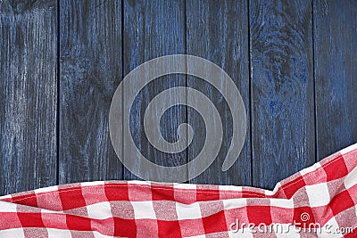 Checkered picnic blanket on color wooden background, top view Stock Photo