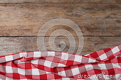 Checkered picnic blanket on wooden background Stock Photo