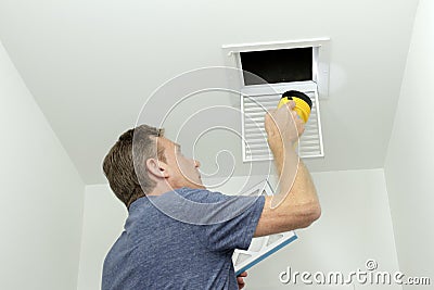 Checking Air Ducts in Home HVAC System Stock Photo