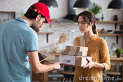 Delivery person checking barcode on the boxes Stock Photo