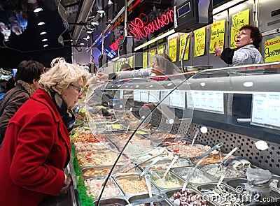 Checking behind the glass on a Belgian market Editorial Stock Photo