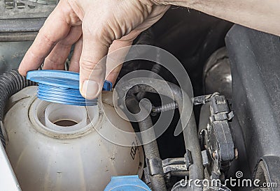Checking car radiator coolant level and add up liqiud Stock Photo