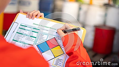 Checking on the chemical hazardous material form. Industrial safety working. Stock Photo