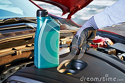 Checking engine oil level in modern car. Winter service for safe driving. Stock Photo