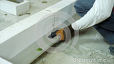 Checking evenness of aerated concrete wall with spirit level Stock Photo