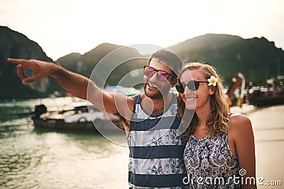 Checking out the sights on their beach stroll. a young couple enjoying a day at the beach. Stock Photo