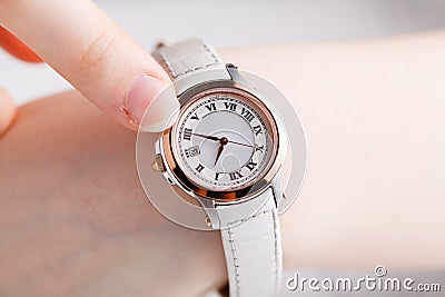 Checking time, female wrist watch on hand Stock Photo