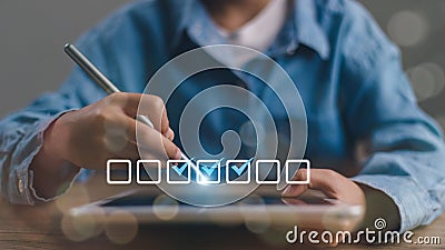 Checklist concept. Businessman using tablet. Checking marks on checkboxes on the futuristic virtual interface screen Stock Photo