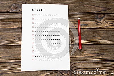 Checklist on a sheet of paper, fountain pen on the background of a wooden table Stock Photo