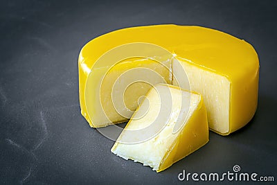 Cheddar Cheese on Black Slate Stock Photo