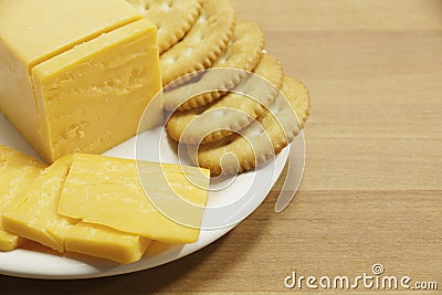 Cheddar Cheese and Crackers on Plate Stock Photo