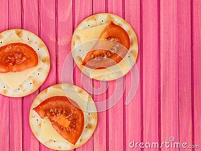 Cheddar Cheese and Tomato Snacks on Water Biscuit Crackers Stock Photo