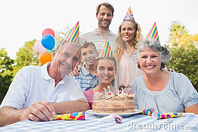 Cheeful family smiling at camera at birthday party Stock Photo