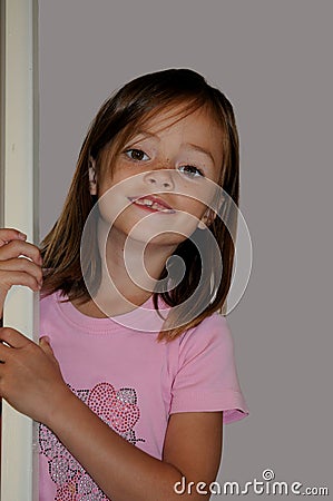 Cheekily schoolgirl with long hair and freckles Stock Photo