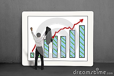 Cheered businessman standing with growth trend and chart on screen Stock Photo