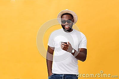 Cheerful African American man in white shirt using mobile phone application. happy dark skinned hipster guy read news Stock Photo