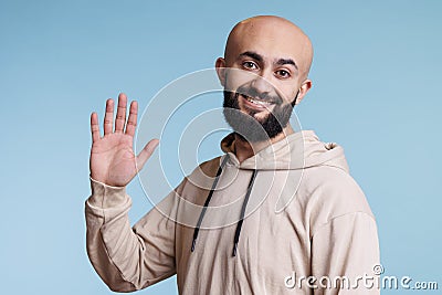 Cheerful arab man waving hi portrait Stock Photo