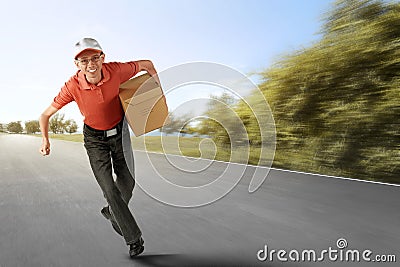 Cheerful asian courier running with holding the package Stock Photo