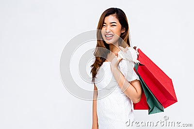 Cheerful Asian lady with paper bags Stock Photo