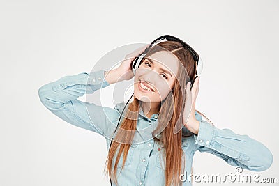 Cheerful attractive young woman in headphones listening to music Stock Photo