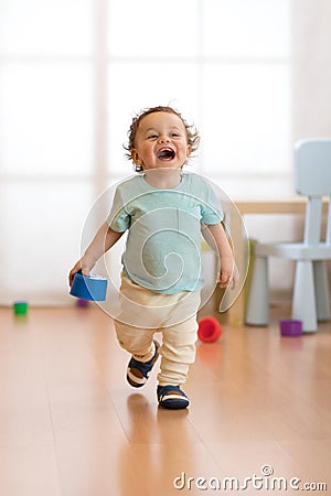 Baby toddler running indoors Stock Photo