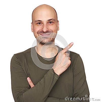 Cheerful bald guy is pointing finger to copy space Stock Photo