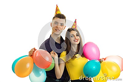 Cheerful beautiful couple celebrating birthday laughing and holding many balls Stock Photo