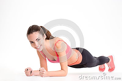 Cheerful beautiful fitness woman doing plank exercise Stock Photo