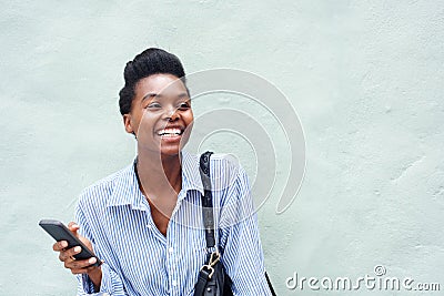 Cheerful black woman holding cell phone Stock Photo