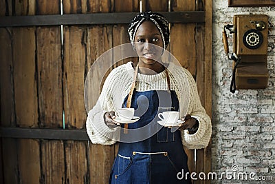 Cheerful black woman serving coffees Stock Photo