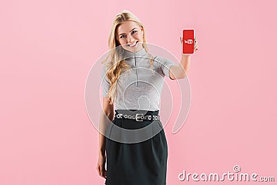 Cheerful blonde girl showing smartphone with youtube app on screen, isolated Editorial Stock Photo
