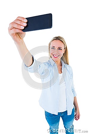 Cheerful blonde taking a selfie with smartphone Stock Photo