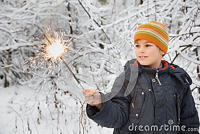 Cheerful boy with Bengal fire in hand in winter Stock Photo