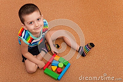 Cheerful boy building a block garage Stock Photo