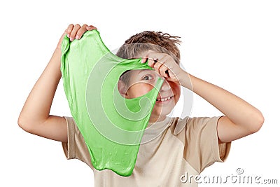 Cheerful boy holding a slime and looking throw its hole. Studio Stock Photo