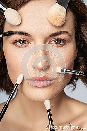 Close up of charming girl that doing makeup Stock Photo