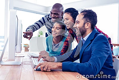 Cheerful business people looking at computer screen Stock Photo