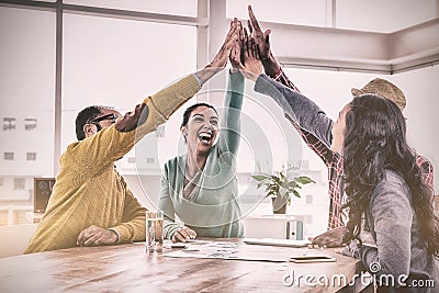 Cheerful business team doing high five in creative office Stock Photo