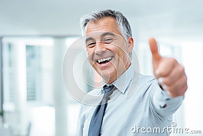 Cheerful businessman thumbs up Stock Photo