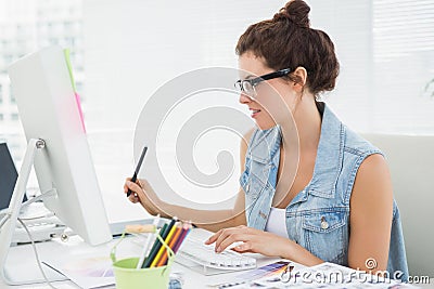 Cheerful casual businesswoman using computer and digitizer Stock Photo