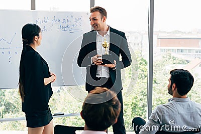 Boss awarding workers during conference Stock Photo